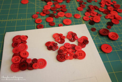 DIY Pet Inspired Button Art - Step 3 - Glue your assorted buttons to fill up the entire LOVE pattern